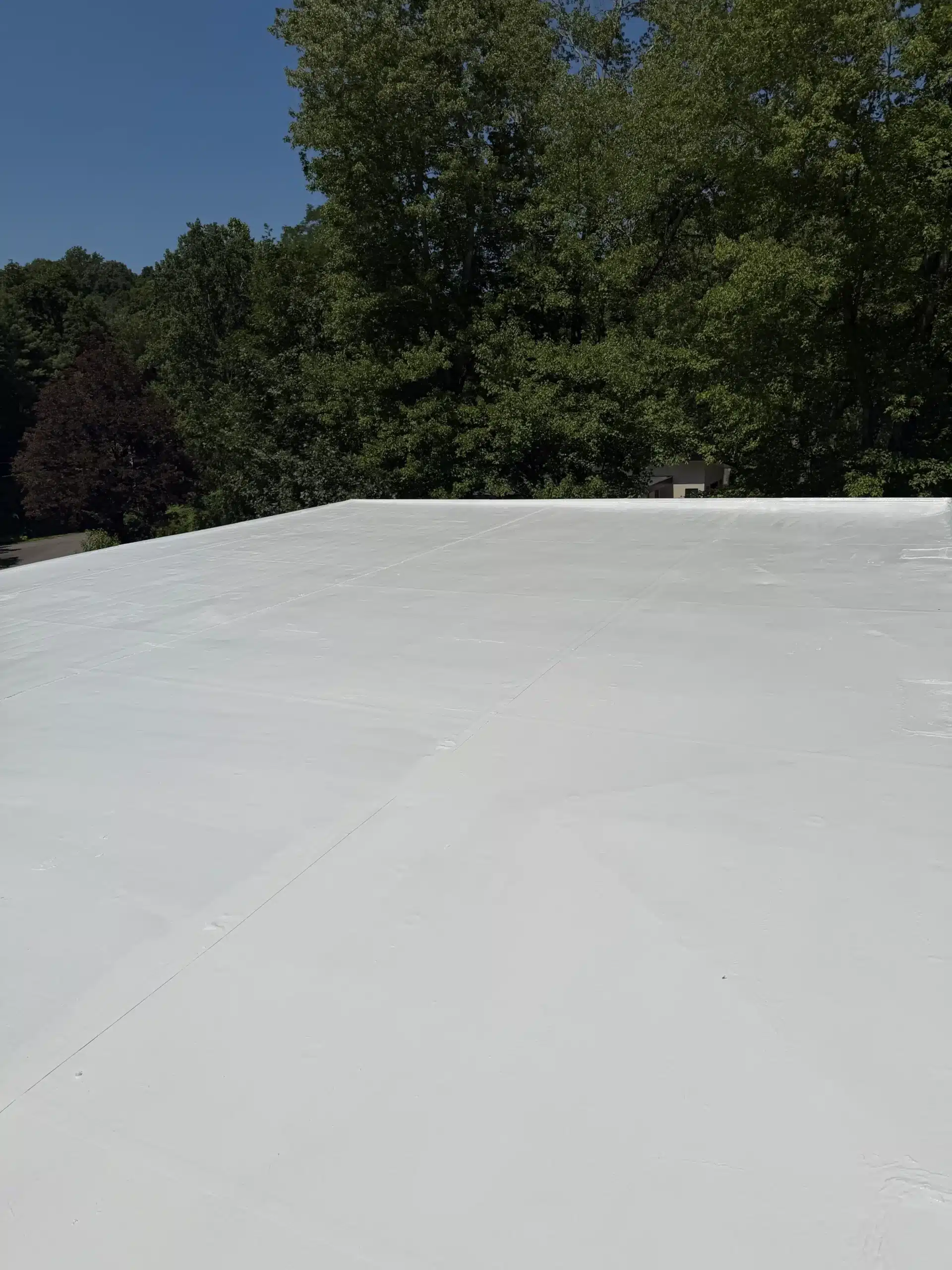 Completed commercial silicone roof coating in Greenwich, CT by City Island Roofing.